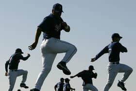 Pitchers and catchers for the Texas Rangers run a drill during their first practice of spring training Thursday, Feb. 16, 2006, in Surprise, Ariz. (AP Photo/Charlie Riedel)