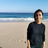 Presenter Anita Rani standing on Porthcurno beach