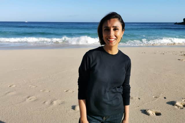 Presenter Anita Rani standing on Porthcurno beach