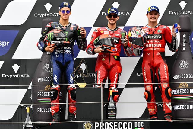 Pecco Bagnaia celebrates winning the Austrian GP with Fabio Quartararo and Jack Miller.
