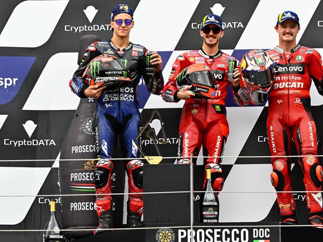Pecco Bagnaia celebrates winning the Austrian GP with Fabio Quartararo and Jack Miller.
