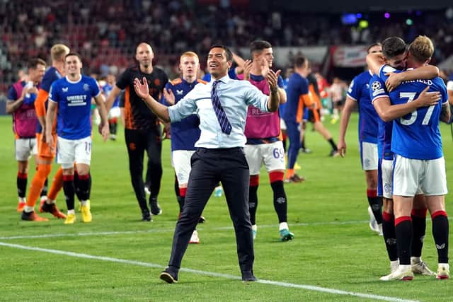 Rangers manager Giovanni van Bronckhorst and his players celebrate last night’s 1-0 win over PSV Eindhoven as victory secured the Scottish side a return to Champions League football for the first time since 2010. Pic by PA.