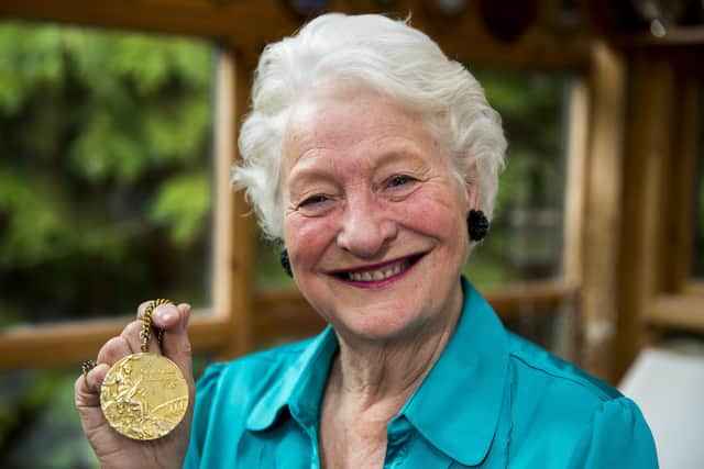 Dame Mary Peters, with her gold medal, at her home