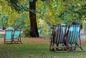 People sit on deckchairs among brown leaves fallen from the trees in St James' Park in London last week. But while Northern Ireland is often autumnal in late August, the south of England can be warm and sunny until the end of September. Photo by Susannah Ireland / AFP