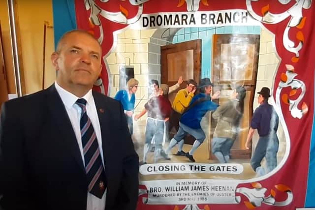 Sammy Heenan alongside an Apprentice Boys banner dedicated to the memory of his father, William James Heena, who was murdered by the IRA. Sammy is part of the working group which organised an exhibition of such banners and drums at Brownlow House to mark Orange Victims's Day 2022.