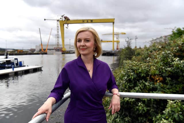 Liz Truss standing next to the Pioneer foil boat that is used to transport crew in offshore wind farms during a campaign visit to the maritime engineering company in Belfast Harbour, as part of her campaign to be leader of the Conservative Party and the next prime minister. Picture date: Wednesday August 17, 2022.