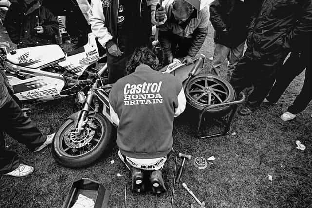 Stephen Davison's famous photograph of the late  Joey Dunlop at work on his race bike in the Tandragee 100 paddock in 1994.