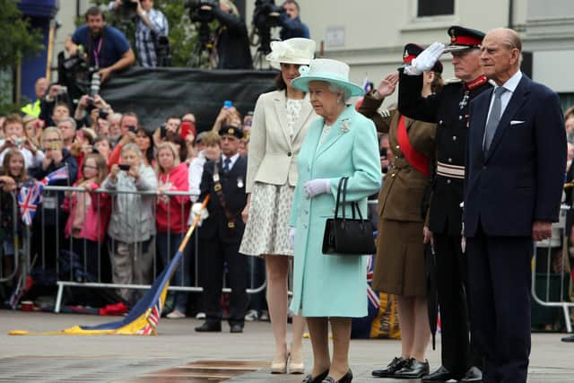 COLERAINE, NORTHERN IRELAND - JUNE 25:  Queen Elizabeth II and Prince Philip, Duke of Edinburgh pay their respects at the cenotaph in Coleraine during the launching of World War One commemorations, on the third and final day of the Queen's visit to Northern Ireland, on June 25, in Coleraine, Northern Ireland. (Photo by Paul Faith - WPA Pool/Getty Images)