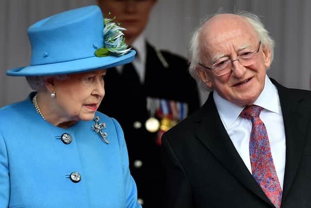 Britain's Queen Elizabeth II stands with Irish President Michael D. Higgins (R) during the ceremonial welcome at the Royal Dais in Windsor, west of London on April 8, 2014. Photo credit: BEN STANSALL/AFP via Getty Images