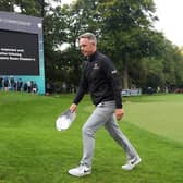 Luke Donald of England leaves the 18th green following the announcement of the death of Her Majesty Queen Elizabeth II during Day One of the BMW PGA Championship at Wentworth Golf Club