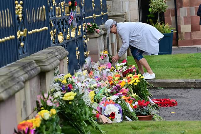Members of the public lay flowers  at Hillsborough Castle in Co Down following the death of Queen Elizabeth II, the UK's longest-serving monarch, who has died at Balmoral aged 96, after reigning for 70 years.
 Pic Colm Lenaghan/Pacemaker