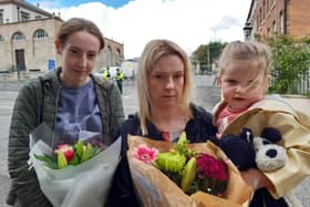 From left: Amelia Murray with Laura and Lily Grierson travelled from Ballynahinch to lay flowers at Hillsborough Castle to show their respect for the Queen.