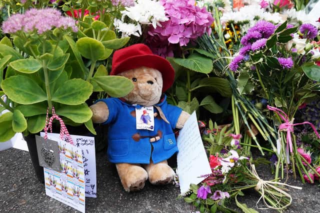 Floral tributes are laid at the gates of Balmoral in Scotland following the death of Queen Elizabeth II on Thursday