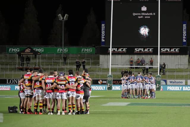 The teams hold a minutes silence to mark the death of Queen Elizabeth II before the round six Bunnings NPC match between Waikato and Auckland at FMG Stadium