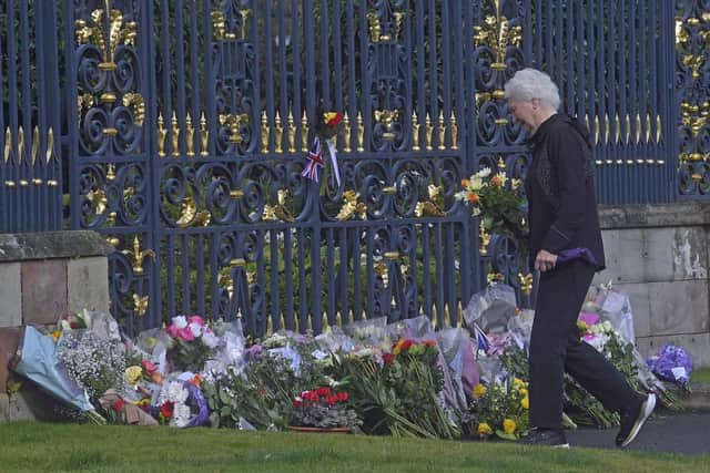 Mary Peters lays flowers at the gates of Hillsborough Castle in County Down, as she pays her respects following the death of Queen Elizabeth II. Photo: Mark Marlow/PA Wire