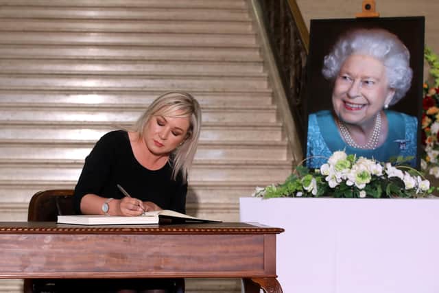 Sinn Fein vice-president Michelle O'Neill, MLA, signs the Book of Condolence for Queen Elizabeth in the Great Hall of Parliament Buildings. Photo: William Cherry/Presseye