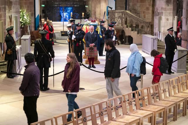 After a queue to get to St Giles Cathedral lasting five or more hours, members of the public file past Charles III and other members of the royal family holding a vigil in honour of Queen Elizabeth II. Photo: Jane Barlow/PA Wire