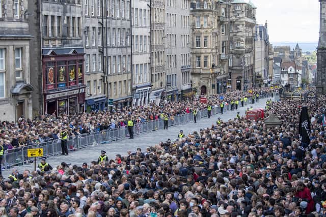 Crowds gather to watch the procession of Queen Elizabeth II's coffin from the Palace of Holyroodhouse to St Giles' Cathedral, Edinburgh. Picture date: Monday September 12, 2022.