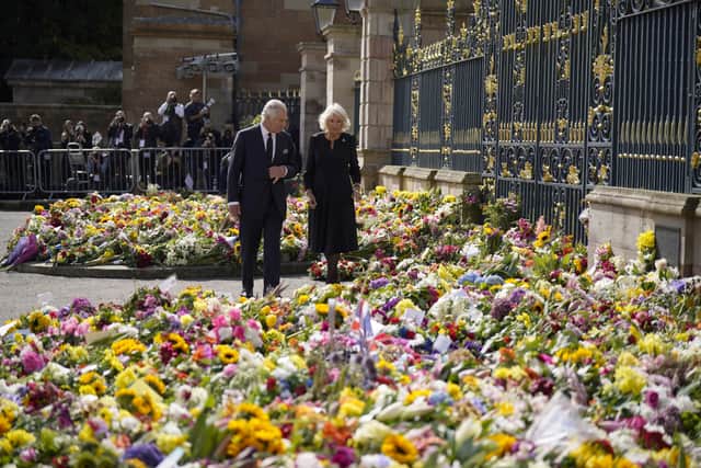 King Charles III and the Queen Consort view floral tributes left outside Hillsborough Castle, Co Down