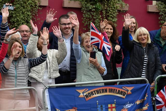 Members of the public gather outside Hillsborough Castle, Co Down, Northern Ireland ahead of a visit by King Charles III and the Queen Consort following the death of Queen Elizabeth II. Picture date: Tuesday September 13, 2022.