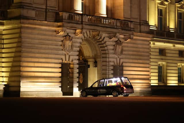 The hearse carrying the coffin of Queen Elizabeth II arrives at Buckingham Palace, London, where it will lie at rest overnight in the Bow Room.