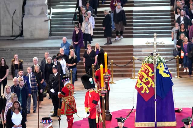 Scottish Secretary Alister Jack (front left) and Secretary of State for Defence Ben Wallace (front right) in ceremonial role as members of the Royal Company of Archers guard the coffin of Queen Elizabeth II, draped in the Royal Standard with the Imperial State Crown and the Sovereign's orb and sceptre, lying in state on the catafalque in Westminster Hall, at the Palace of Westminster, London, ahead of her funeral on Monday. Picture date: Thursday September 15, 2022.