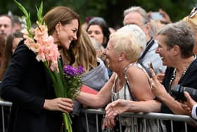 The Princess of Wales meeting wellwishers as she views floral tributes left by members of the public at the gates of Sandringham House in Norfolk