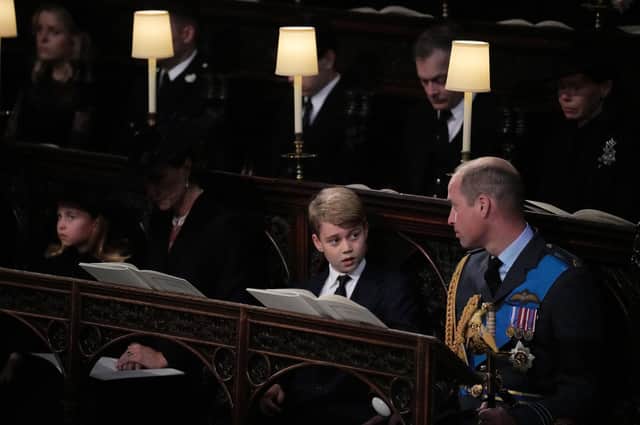 (front row, left to right) Princess Charlotte, the Princess of Wales, Prince George, and the Prince of Wales, watch as the Imperial State Crown and the Sovereign's orb and sceptre are removed from the coffin of Queen Elizabeth II, draped in the Royal Standard, during the Committal Service at St George's Chapel in Windsor Castle, Berkshire.