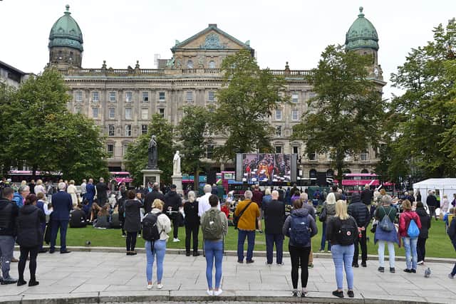 Crowds watch the Queen's funeral on big screens at Belfast City Hall. 
Picture: Arthur Allison/Pacemaker Press