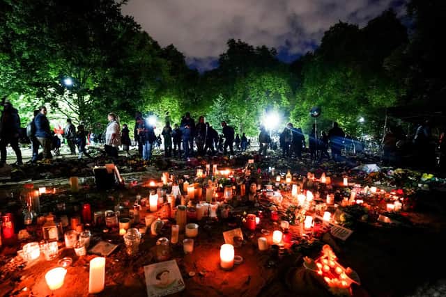 Candles are lit in memory of Queen Elizabeth II in Green Park outside of Buckingham Palace.