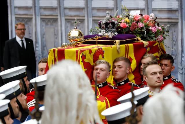 The coffin of Queen Elizabeth II being carried by pallbearers at the State Funeral held at Westminster Abbey, London