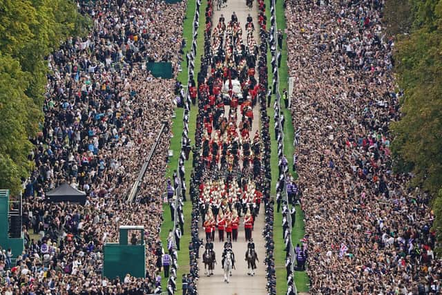 Part of the vast crowd as the ceremonial procession of the coffin of Queen Elizabeth II travels down the Long Walk as it arrives at Windsor Castle for the Committal Service at St George's Chapel on Monday September 19, 2022