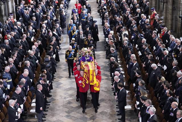King Charles III, the Queen Consort, the Princess Royal, Vice Admiral Sir Tim Laurence, the Duke of York, the Earl of Wessex, the Countess of Wessex, the Prince of Wales, the Princess of Wales, Prince George, Princess Charlotte, the Duke of Sussex, the Duchess of Sussex, Peter Phillips and the Earl of Snowdon follow behind the coffin of Queen Elizabeth II, draped in the Royal Standard with the Imperial State Crown and the Sovereign's orb and sceptre, as it is carried out of Westminster Abbey after her State Funeral. Picture date: Monday September 19, 2022.