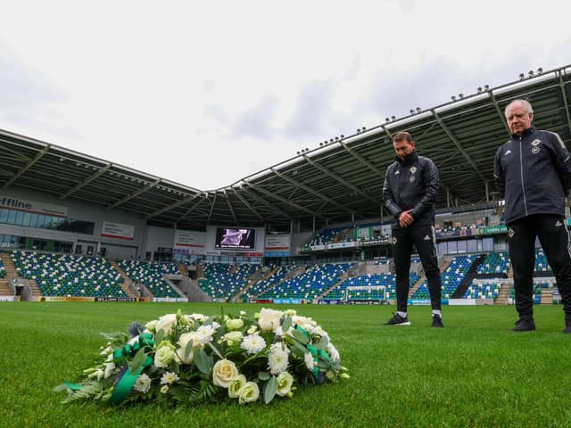 Northern Ireland manager Ian Baraclough (left) and his assistant, Jimmy Nicholl, observe a moment of reflection at the National Football Stadium at Windsor Park in tribute to Queen Elizabeth II. Pic by PressEye Ltd.