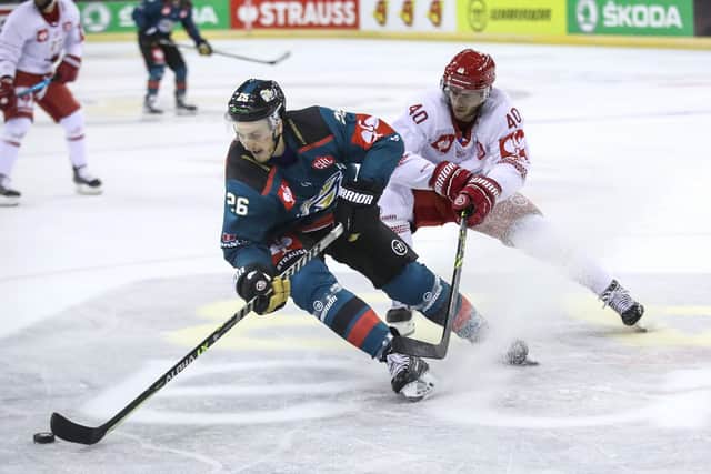 Belfast Giants' Mark Cooper #26 with Ocelari Trinec's Milos Roman #40 during the Champions Hockey League game at the SSE Arena, Belfast