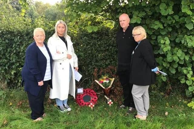 Relatives of John Eagleson lay flowers at the roadside at Kildress, near Cookstown, Co Tyrone on 21 September 2022 in his memory. From left: Gwen Owen, Emma Eagleson, Clive Eagleson and Jeanelle Curran. Mr Eagleson, who was 49 and had three children, was shot by the IRA as he drove to work on 1 October 1982.