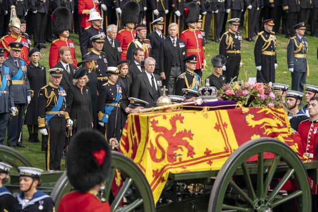 King Charles III, the Duke of Sussex, the Queen Consort,the Duchess of Sussex, the Princess Royal, Princess Beatrice, Peter Phillips, the Duke of York, the Earl of Wessex and the Countess of Wessex look on as the State Gun Carriage carrying the coffin of Queen Elizabeth II arrives at Wellington Arch during the Ceremonial Procession following her State Funeral at Westminster Abbey, London.