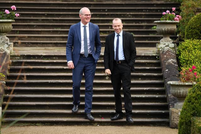 Ireland’s foreign minister Simon Coveney and the secretary of state Chris Heaton-Harris interact warmly at Hillsborough yesterday.   Photo by Kelvin Boyes / Press Eye
