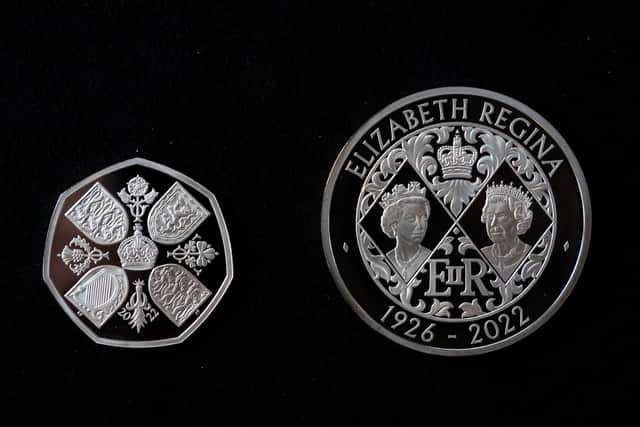 A 50 pence and £5 Crown commemorating the life and legacy of Queen Elizabeth II, during an announcement regarding the designs for the new coins and notes depicting King Charles III at the Worshipful Company Of Cutlers, at Cutlers' Hall, London.