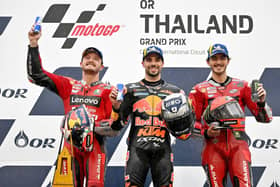 Thailand MotoGP race winner Miguel Oliveira on the rostrum with runner-up Jack Miller (left) and Pecco Bagnaia.
