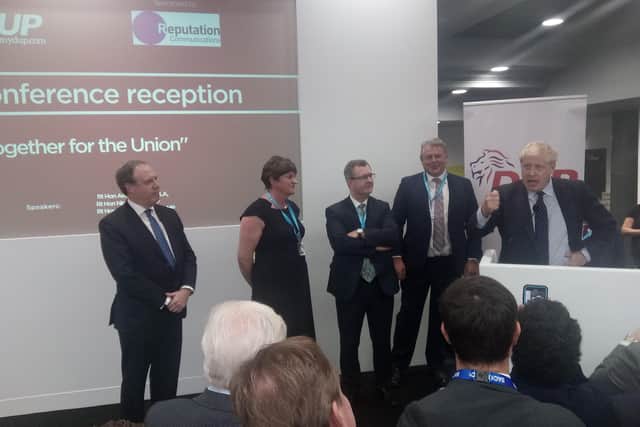 The absence of the DUP at this year's conference was in contrast to 2019, pictured. Then Nigel Dodds MP, Arlene Foster MLA and Sir Jeffrey Donaldson MP listened to the then prime minister, Boris Johnson, address their packed DUP drinks reception to cheers