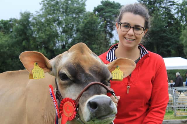 Kristina Fleming with the Jersey and interbreed dairy champion at the Randox Antrim Show. Pic: Julie Hazelton