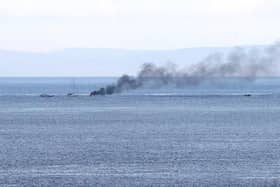 A boat carrying two people burst into flames this evening after 8pm a number of miles off shore between Ballycastle and Rathlin Island in Co Antrim, it is understood the two onboard jumped into the sea and were rescued by a passing boat. RNLI later transported two people to Ambulance waiting at Ballycastle. Pic Kevin McAuley/McAuley Multimedia