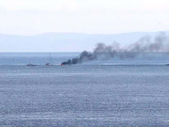 A boat carrying two people burst into flames this evening after 8pm a number of miles off shore between Ballycastle and Rathlin Island in Co Antrim, it is understood the two onboard jumped into the sea and were rescued by a passing boat. RNLI later transported two people to Ambulance waiting at Ballycastle. Pic Kevin McAuley/McAuley Multimedia