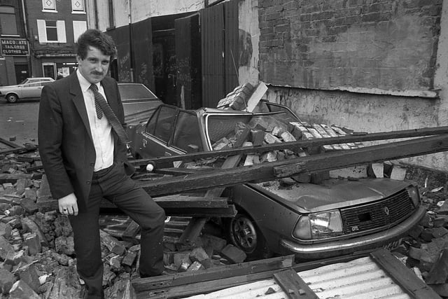 Mr Alan Robinson of Silverstream, Bangor, pictured in November 1982, standing beside his Renault car which was completely wrecked when a wall collapsed in King Street, Bangor, during high winds. Mr Robinson had just parked the car a couple of minutes earlier. Picture: News Letter archives