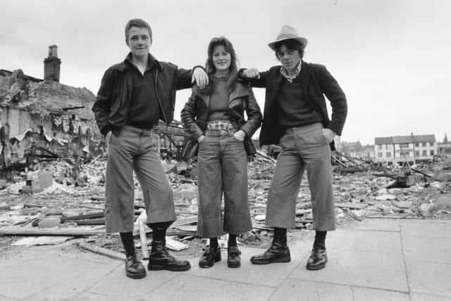 4th June 1974:  Teenagers wearing the latest trend, cropped trousers known as 'parallels', in the ruins of Smithfield Market in Belfast, Northern Ireland. (Photo by Frank Tewkesbury/Evening Standard/Hulton Archive/Getty Images)