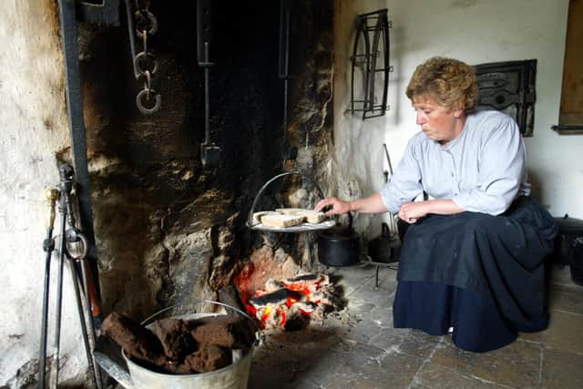 Ruth Gillings doing some baking the old fashion way at the Ulster Folk and Transport Museum in preparation for The Food for the Table event which was held at the museum in July 2002. Picture: Gavan Caldwell/News Letter archives