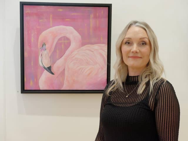 Artist Michelle Wilson with her Pretty in Pink painting.