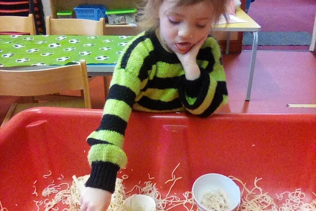 Looking closely at noodles at First Steps nursery in Buxton