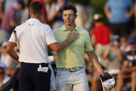 Rory McIlroy of Northern Ireland and Wyndham Clark of the United States shake hands on the 18th green during the third round of the TOUR Championship at East Lake Golf Club. PIC: Cliff Hawkins/Getty Images